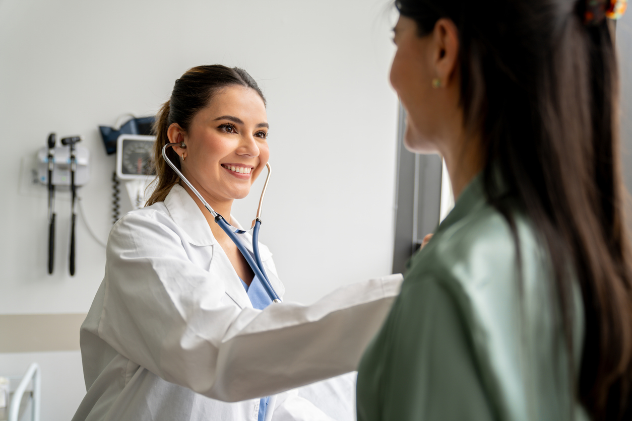 A Nurse Practitioner in a White Coat Is Taking the Vital Signs of a Patient in a Clinical Setting.