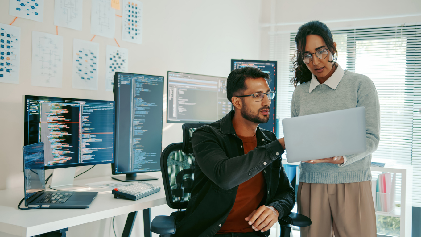 Two Cybersecurity Specialists Review Code on a Laptop..jpg