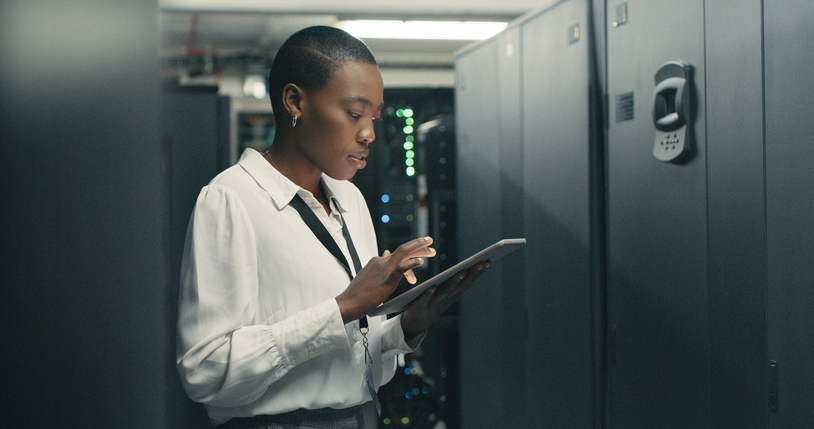 A network security professional working on a tablet.
