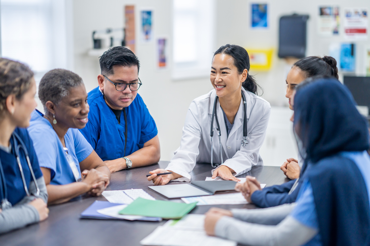  A group of caregivers gathered around a table.